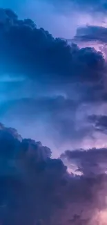 Vibrant wallpaper of a cloudy sky glowing in blue and purple hues.