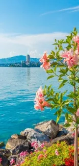 Beautiful view of pink flowers against a vibrant blue ocean and sky.