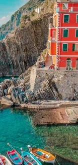 A scenic view of a red house and boats on a turquoise coastal landscape.