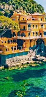 Yellow villa overlooking a vibrant turquoise sea on a sunny day.