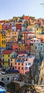 Colorful cliffside village by the sea, lush and vibrant.