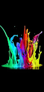 Vibrant splash of rainbow colors on black background wallpaper.