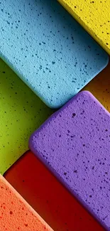 Vibrant geometric wallpaper with colorful blocks in blue, yellow, red, and purple hues.