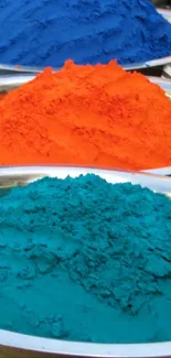 Vibrant colored powders in blue, orange, and teal bowls.