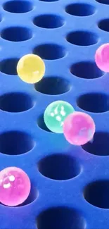 Colorful balls on a perforated blue surface.