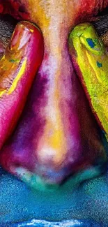 Vibrant painted face with colorful fingers close-up wallpaper.