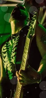 Guitarist playing on stage under green lights with a vivid, lively atmosphere.