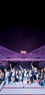 Crowded concert with performers on stage under dark sky.