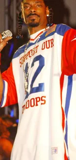 Vibrant concert image with performer in red, white, and blue attire holding mic.