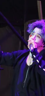 Vibrant performer on stage with purple hair and captivating energy.