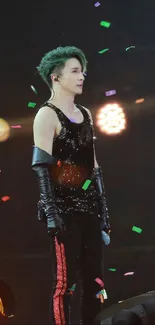 Energetic concert performer with colorful lights on stage.