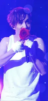 Performer at concert holding red rose under purple lights.