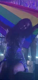 Colorful concert scene with rainbow flag and lights.