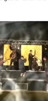 Live band performing on a brightly lit stage with yellow backgrounds.