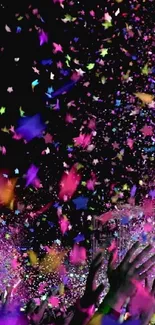 Vibrant confetti explosion against a dark background at a lively celebration.