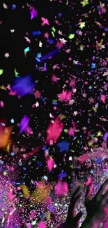 Vibrant confetti with colorful stars dancing over a dark background.