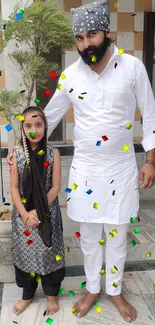 People standing with confetti in vibrant festive attire.