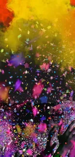 Colorful festival confetti with hands raised in celebration.