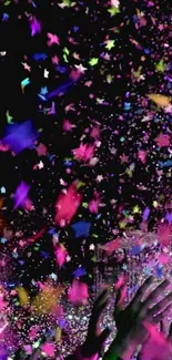 Vibrant confetti and hands reaching up in a celebration scene.