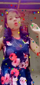 Girl in a floral dress with colorful confetti background.