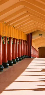 Vibrant red columned corridor with shadows.