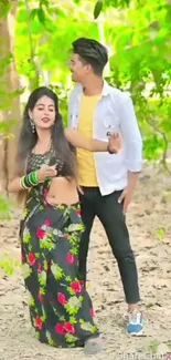 Couple dancing in colorful outfits amidst nature.