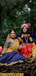 Two women in vibrant traditional attire sit among trees in a colorful, lively setting.