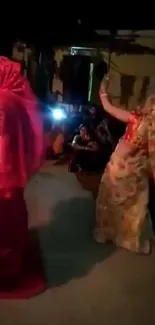 Colorful traditional dance scene with women performing at night.