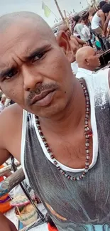 Man amidst cultural festival with vibrant colors.