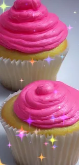 Two cupcakes with vibrant pink frosting on a white background.