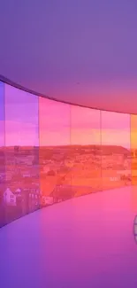 Curved glass corridor with colorful city view.