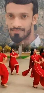 Dancers in red with a large portrait above.