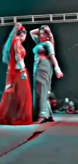 Two vibrant dancers performing on a stage.