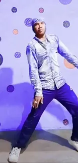 Man striking a dynamic dance pose against a colorful dotted background.