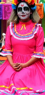 Day of the Dead celebration with colorful pink dress and makeup.