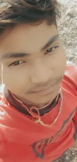 Youthful portrait in red shirt outdoors.