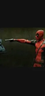 Deadpool pointing at a blue teddy bear in a humorous standoff.