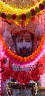 Vibrant deity idol with colorful garlands and intricate details.