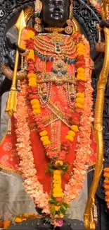 Colorful deity adorned with flowers and vibrant attire.