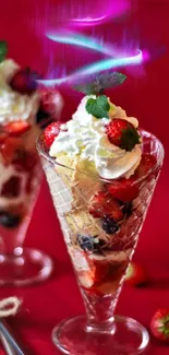 Vibrant dessert with berries and cream in a glass cup on a red background.