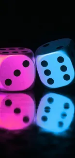 Neon pink and blue dice reflecting on a black surface.