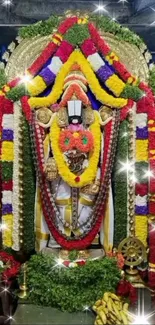 Colorful deity adorned with floral garlands and golden ornaments.