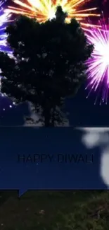 Diwali night wallpaper with colorful fireworks behind a tree silhouette.