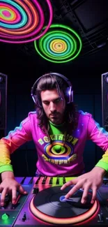 DJ in neon lights with colorful turntables and speakers.