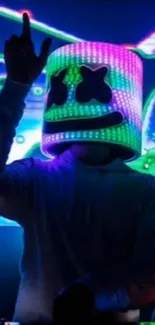 DJ with neon helmet in vibrant lights.