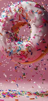 Colorful donut with sprinkles on a pink background.