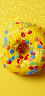 A vibrant donut with colorful sprinkles on a yellow background.