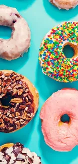 Colorful donuts on a turquoise background wallpaper.