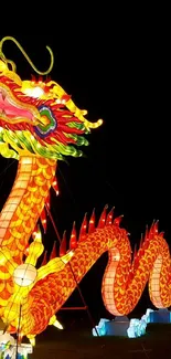 Vibrant dragon lantern glowing at night festival event.