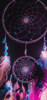 Vibrant dreamcatcher with neon feathers on a dark background.